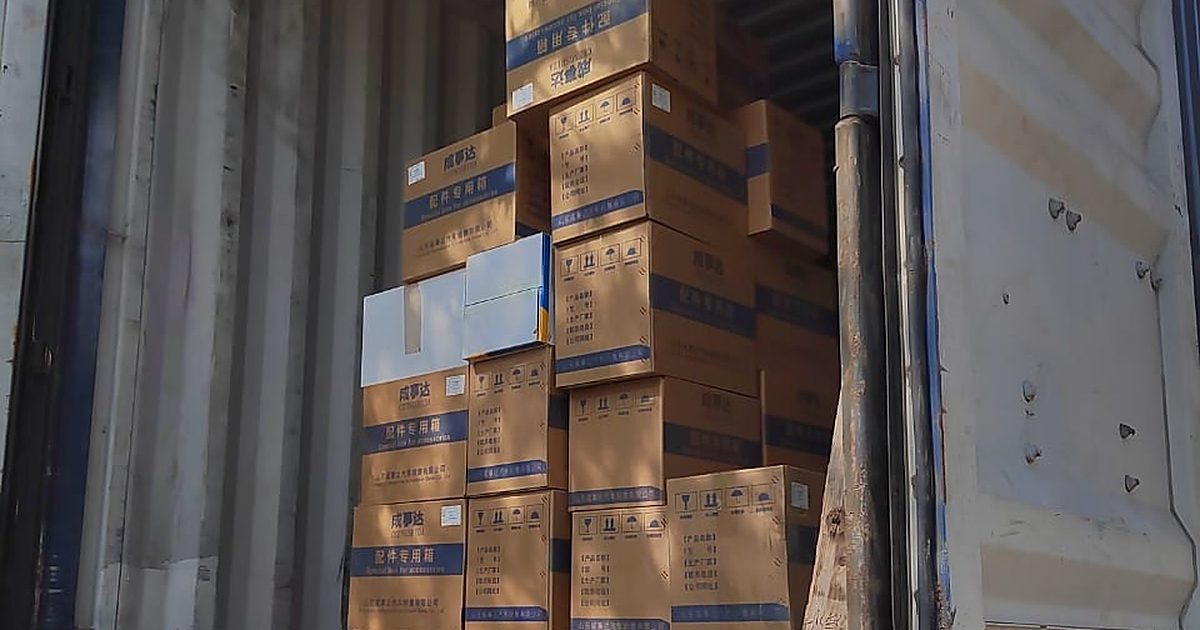 Auto parts cartons stacked on pallets in a partly loaded container in China
