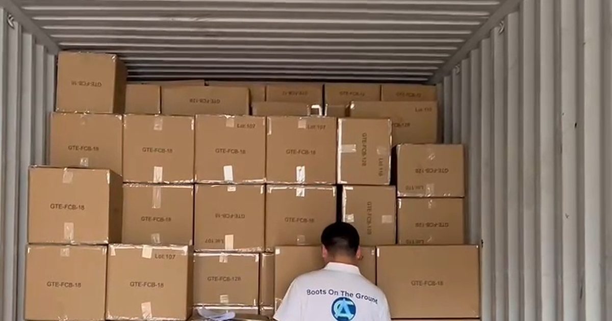 China Agent staff member checking a loaded container of cartons, Boots On The Ground shirt
