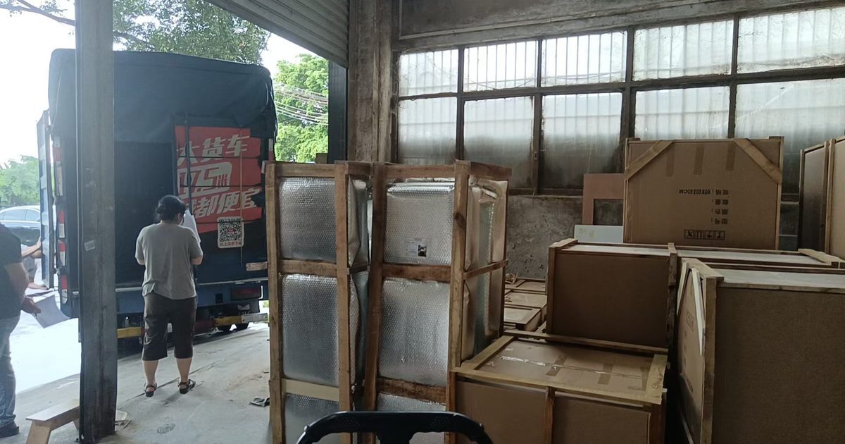Crated and boxed furniture waiting at the loading bay of a factory in China