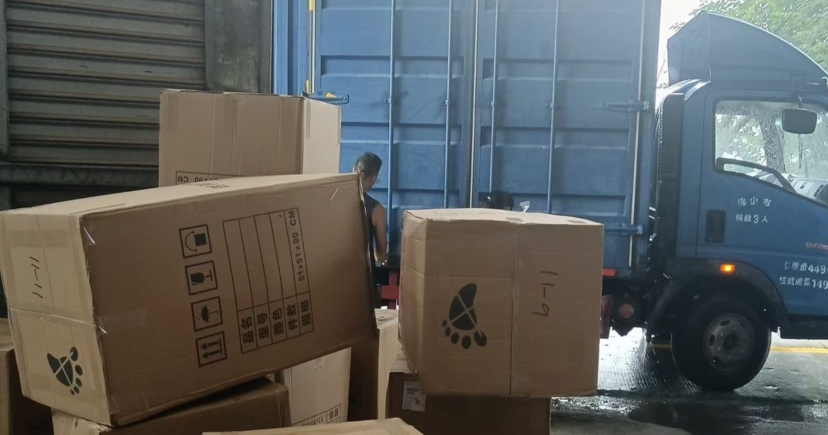 Crated and boxed furniture waiting at the loading bay of a factory in China
