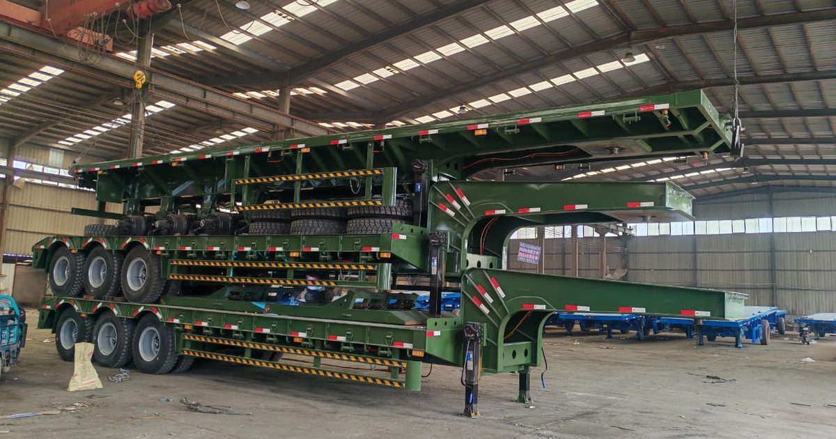Finished lowbed trailers in the assembly hall of a Chinese trailer factory