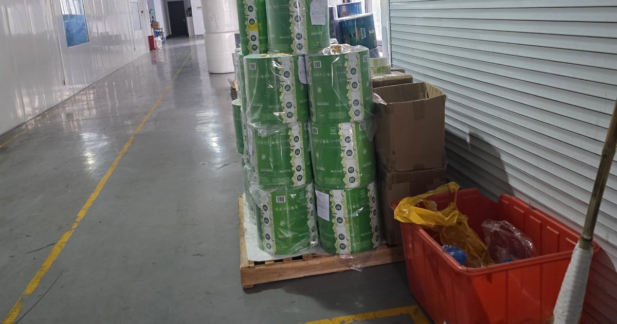 Pallet of private-label wipes rolls in a production corridor at a Chinese factory